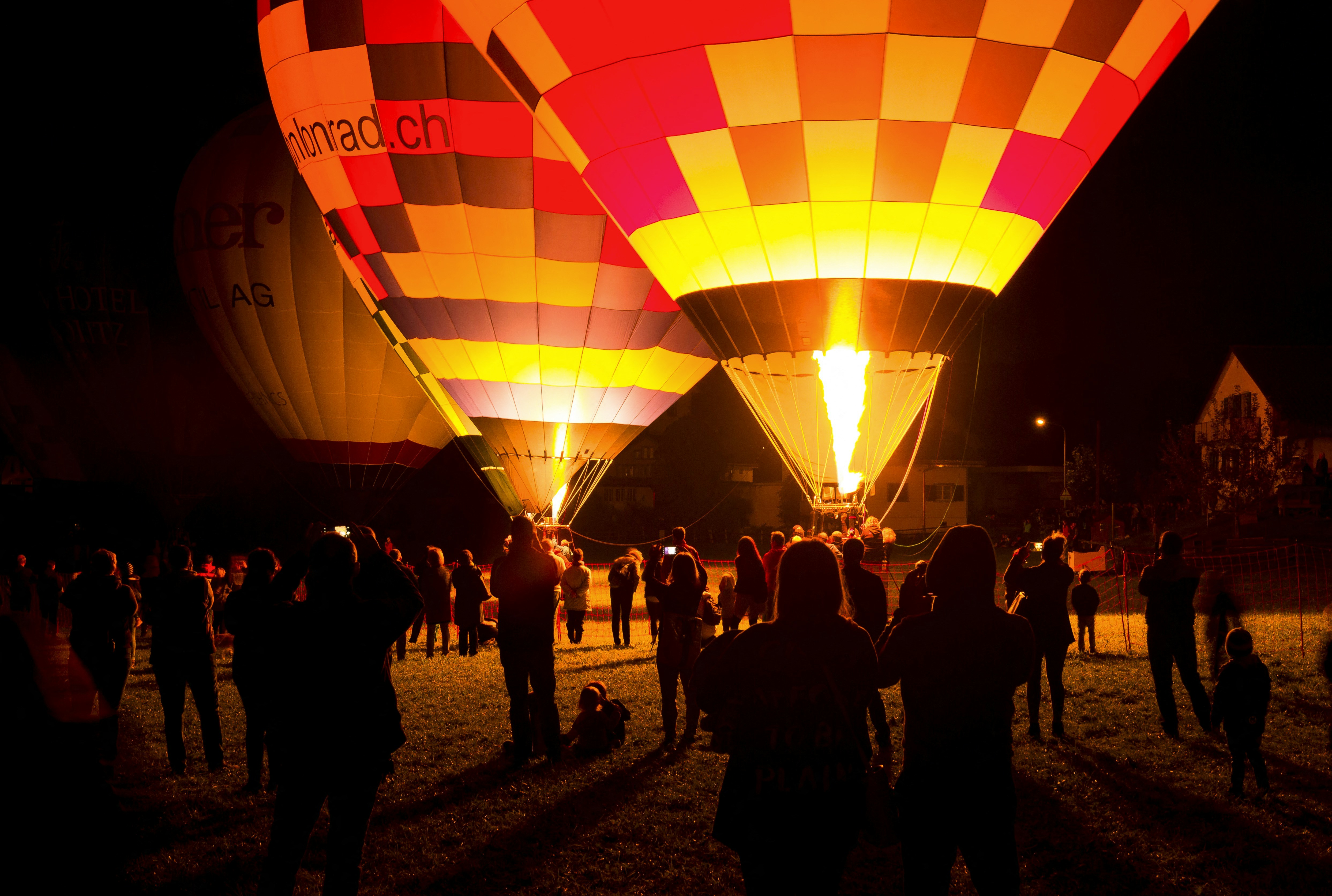 people standing near hot air balloons during daytime