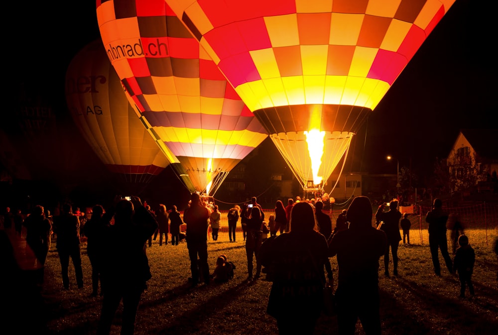 people standing near hot air balloons during daytime