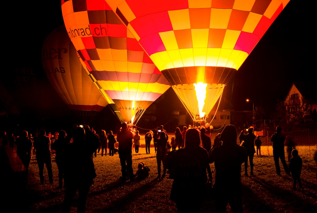 people standing near hot air balloons during daytime