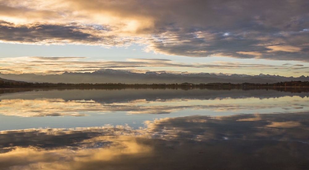 body of water under cloudy sky during daytime