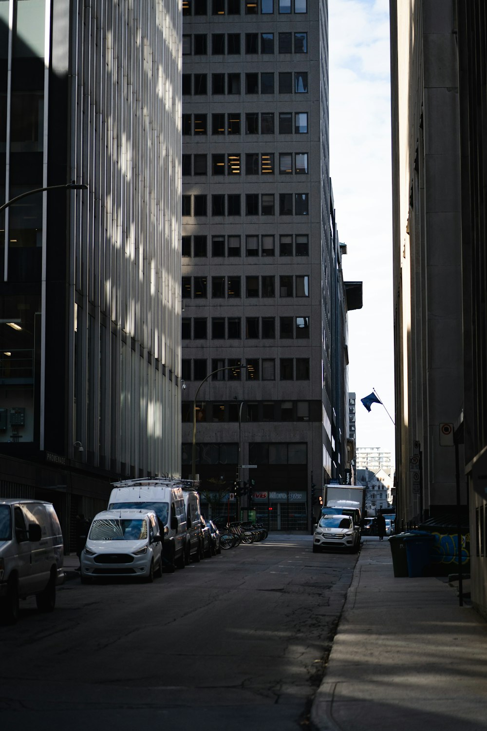 cars on road near high rise buildings during daytime