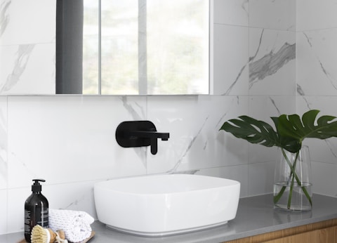 white ceramic sink with faucet