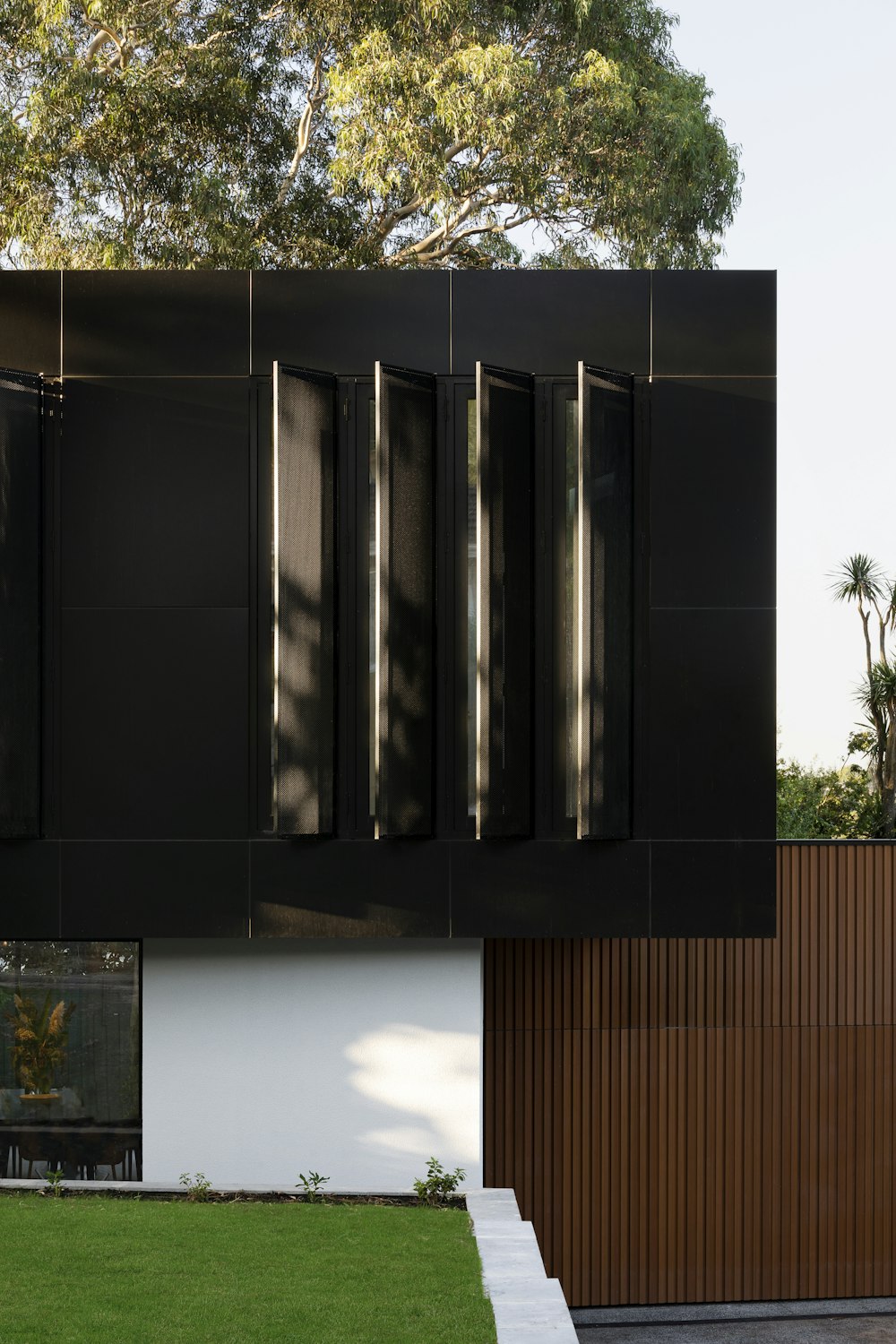 black wooden cabinet near green tree during daytime