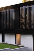 Elegant exterior facade with modern finishes and subtle landscaping designed by Arjilli Interiors.