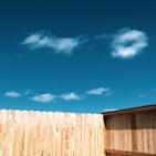 brown wooden fence under blue sky during daytime