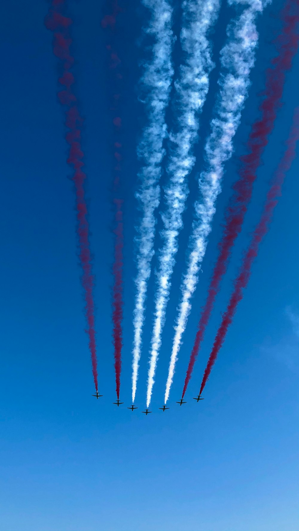 red and white smoke on blue sky