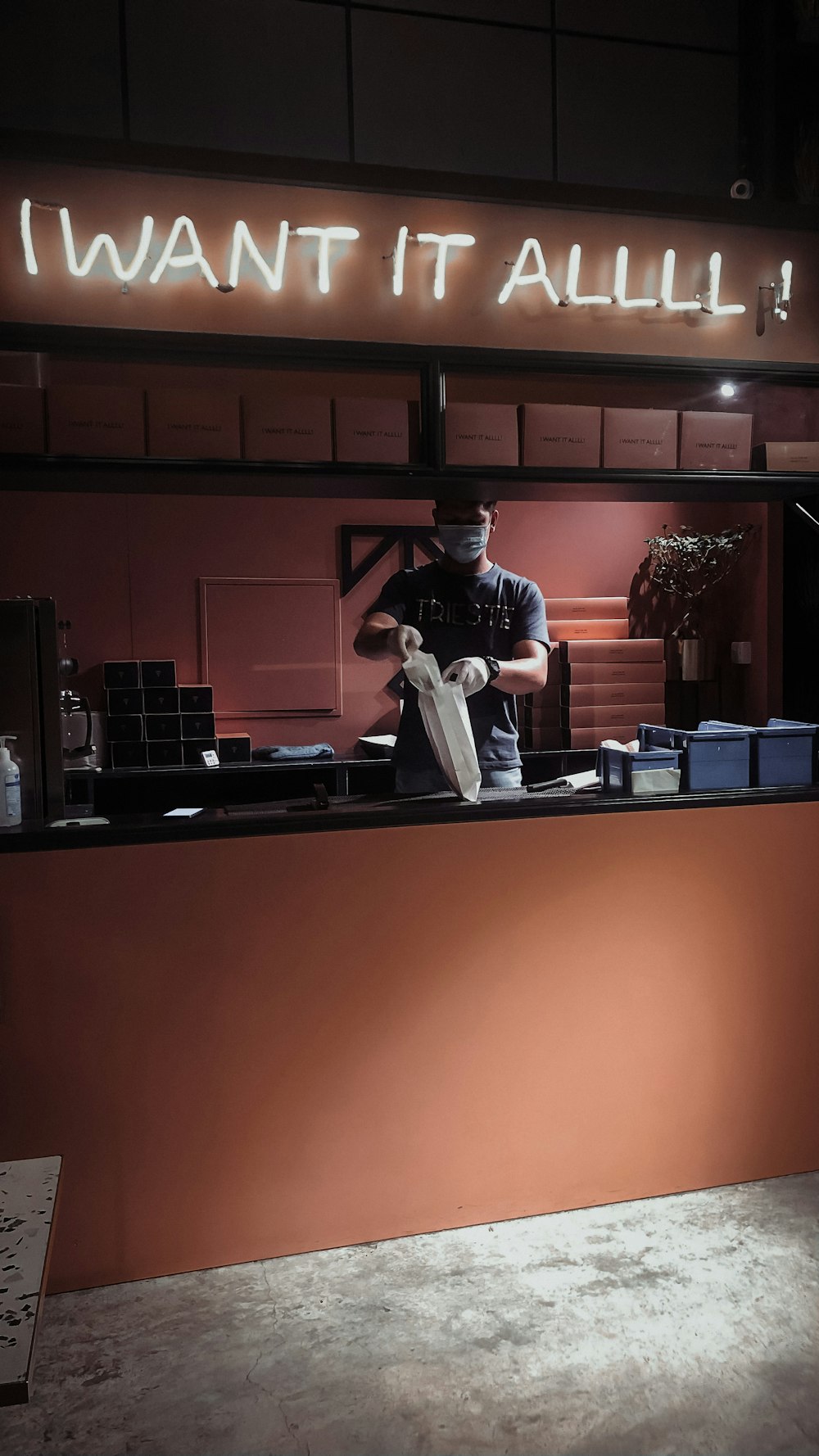 man in black shirt and black pants standing near counter