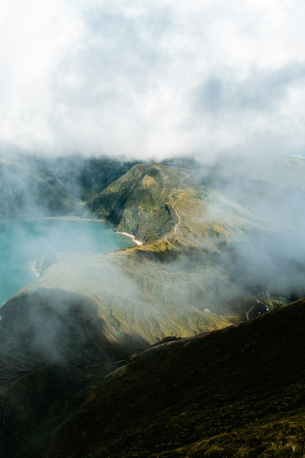 green mountain under white clouds during daytime