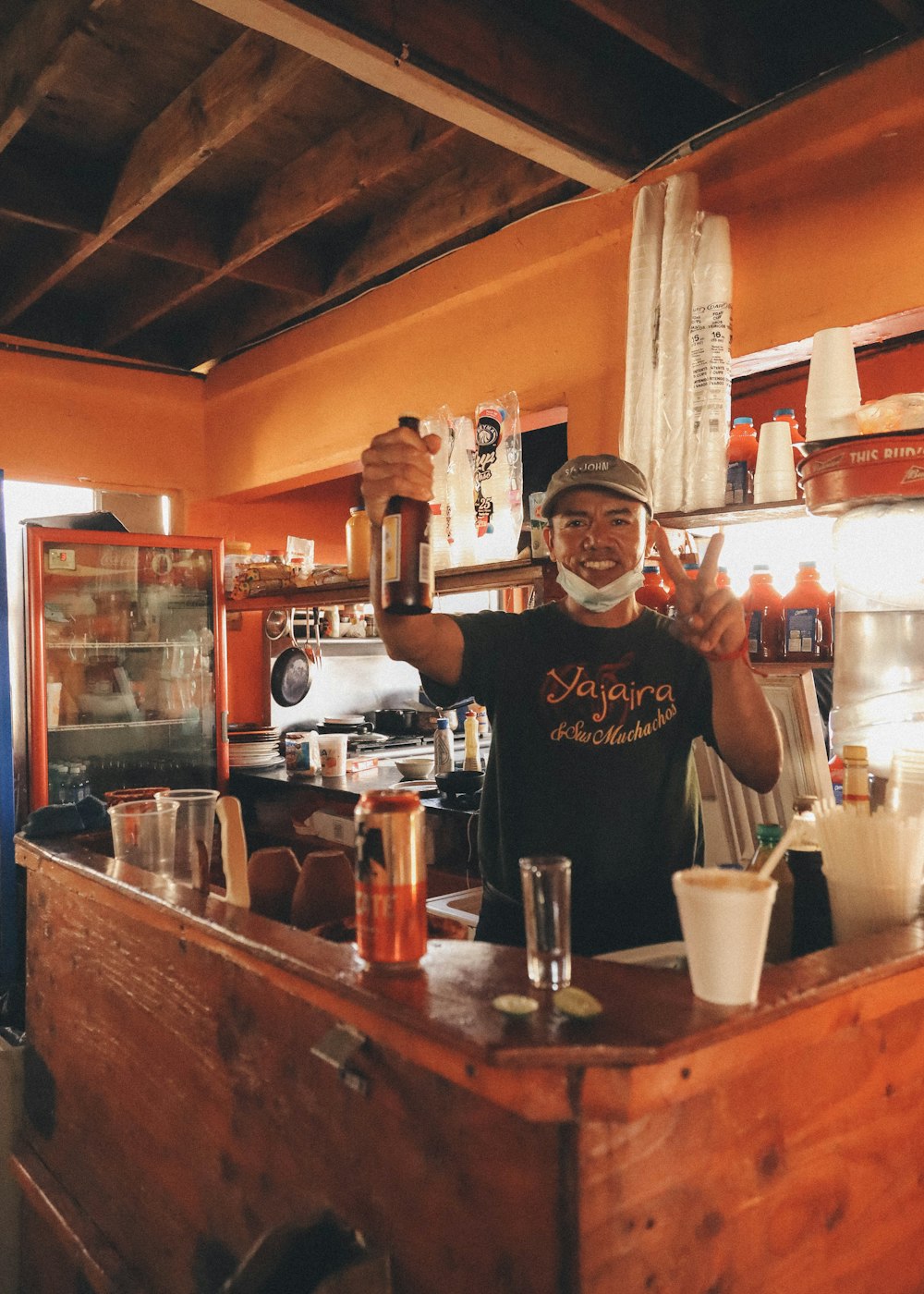 man in black crew neck t-shirt holding beer mug