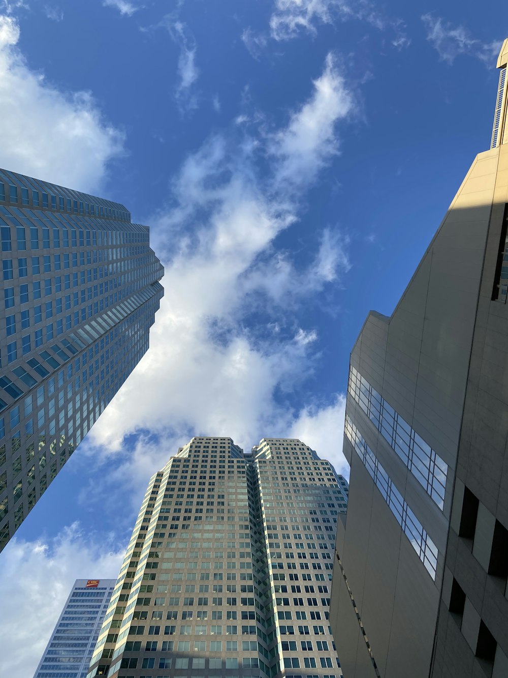 low angle photography of high rise buildings under blue sky during daytime