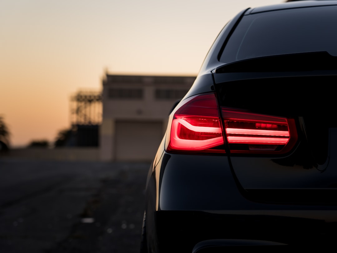 black car on road during sunset