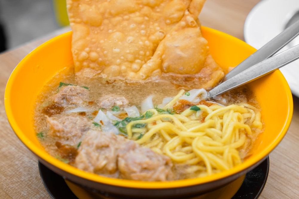 yellow ceramic bowl with noodles