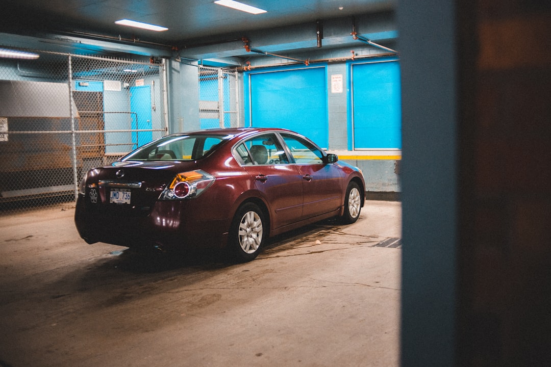 black sedan parked in front of building