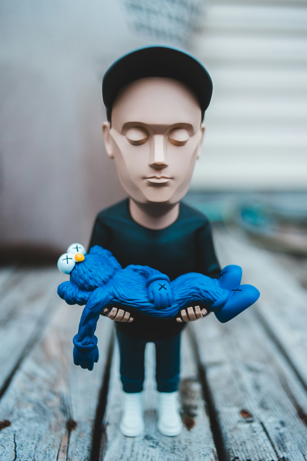 man in blue long sleeve shirt and black hat figurine