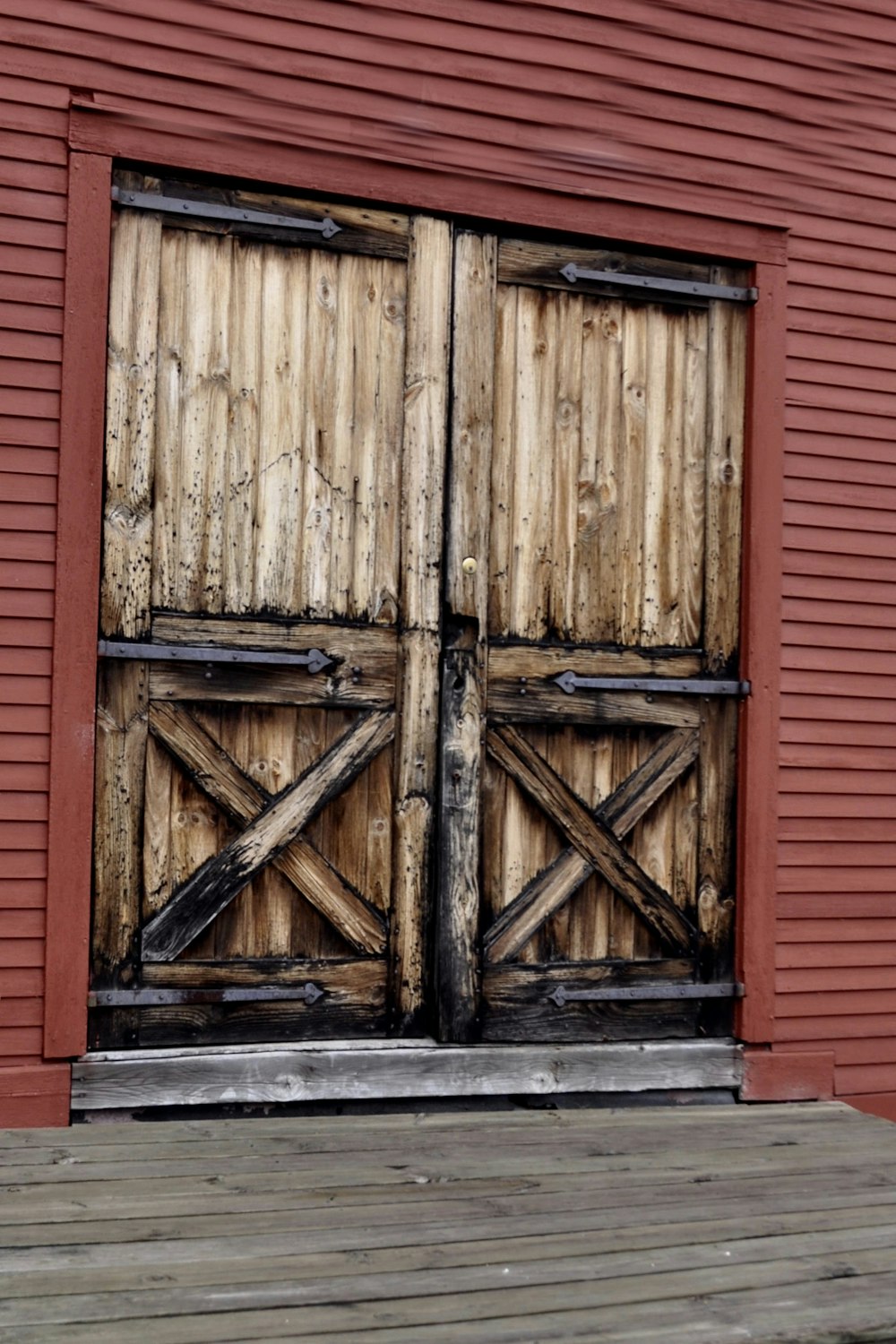 brown wooden door with red wall