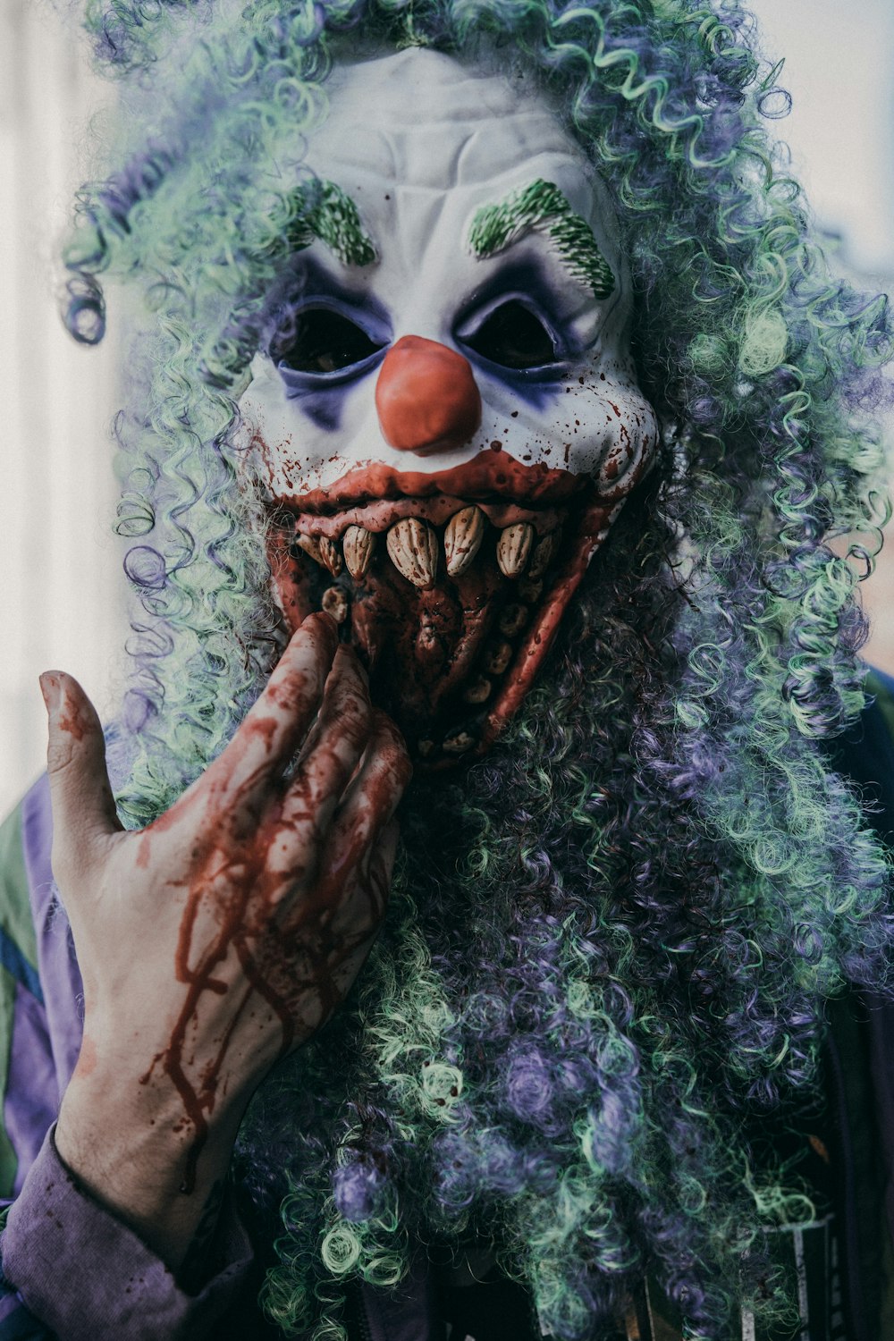 a clown with green hair and a creepy face