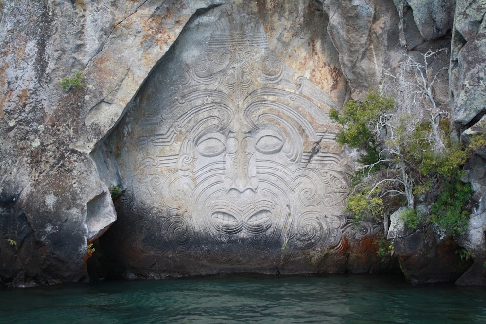 body of water between gray rock formation during daytime