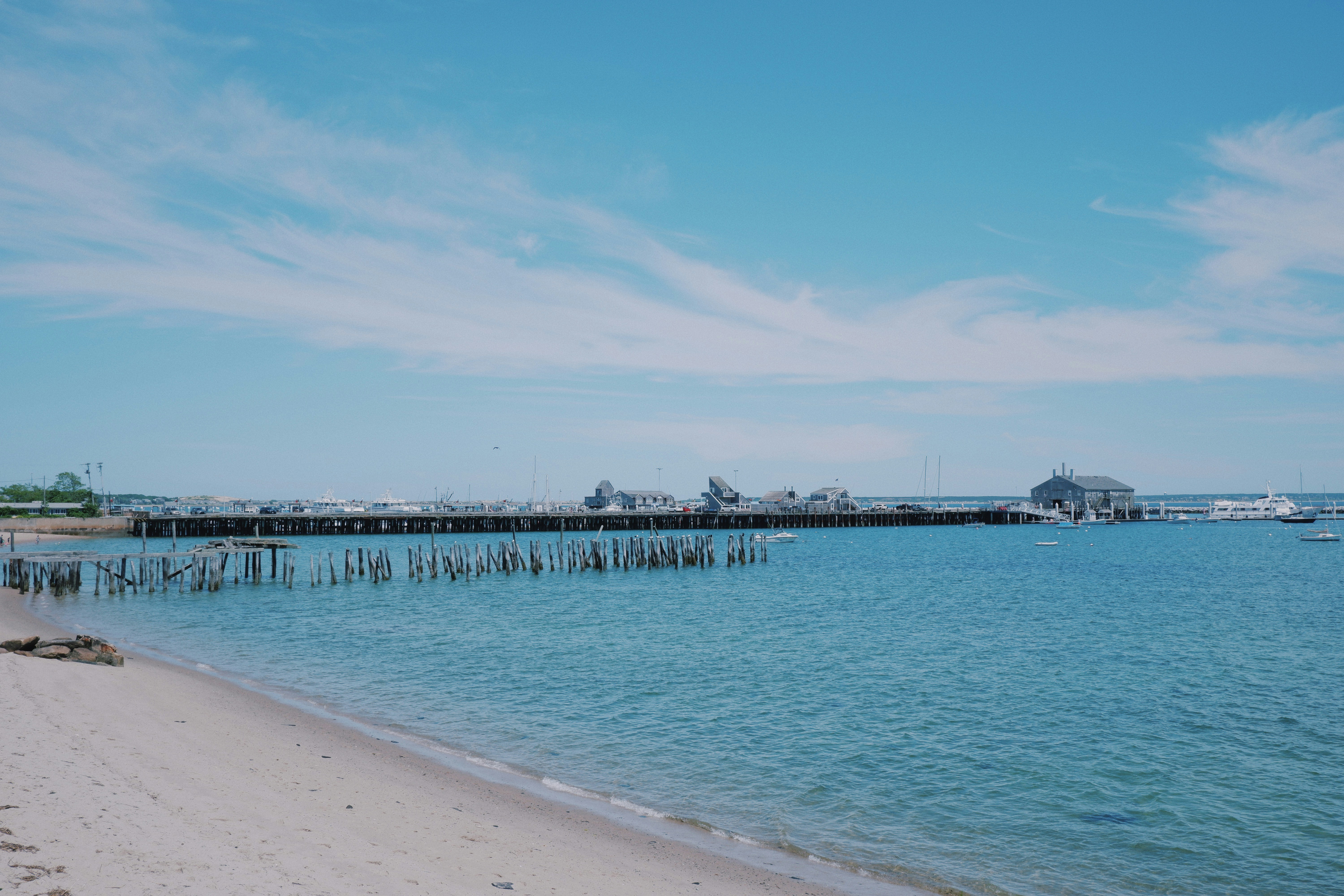 white wooden dock on sea under blue sky during daytime cape cod zoom background