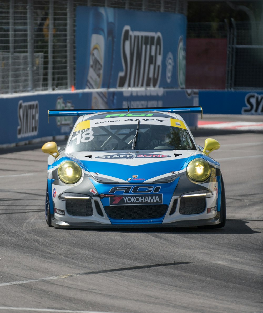 blue and yellow porsche 911 on race track
