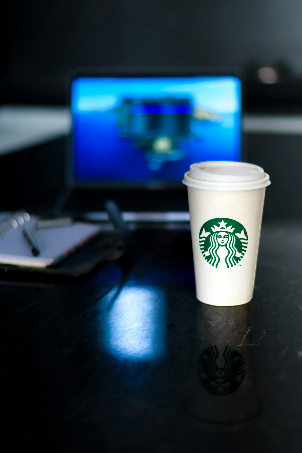 white starbucks disposable cup on black table