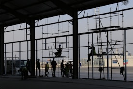 Construction workers collaborating on a large building site