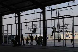 Construction workers collaborating on a commercial building site in Hyderabad.