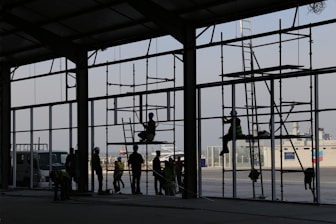 Construction workers collaborating on a large building site