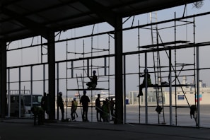 A team of construction workers collaborating on a large commercial building frame