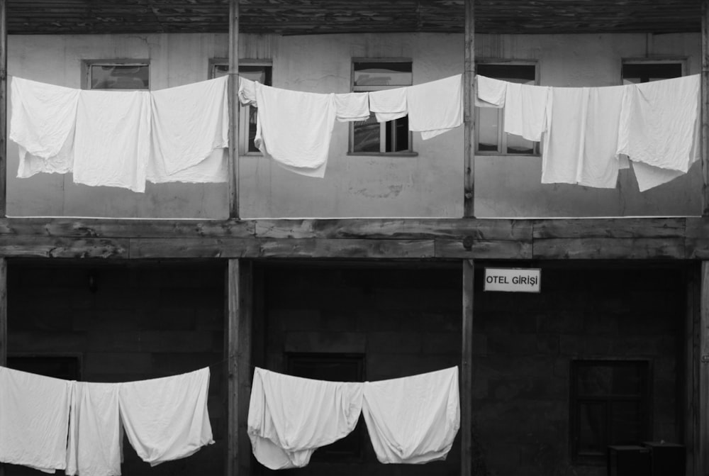 white textile hanging on white metal bar