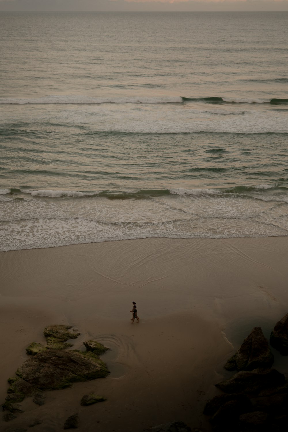 person walking on beach during daytime