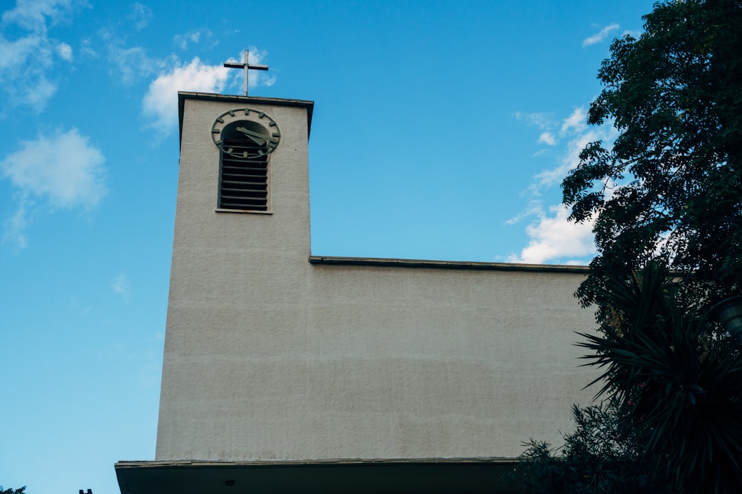 white concrete building with cross on top