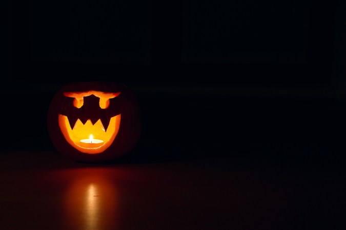 Glowing carved jack-o-lantern at night, setting the mood for family Halloween events around Las Vegas in October