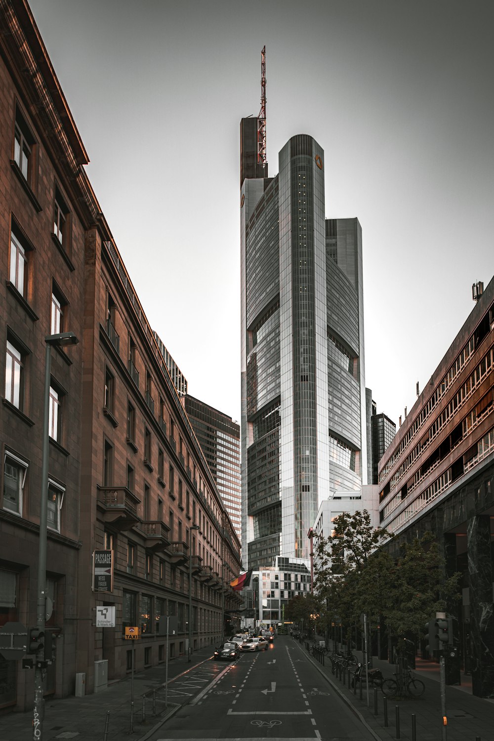 cars parked beside brown concrete building during daytime