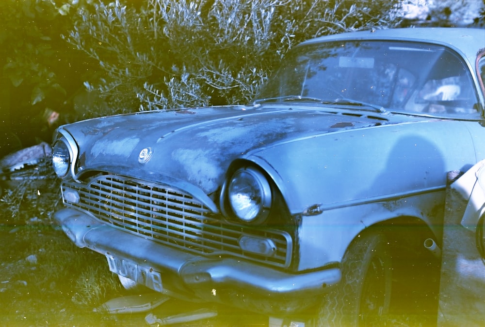 blue classic car on water