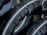 Close-up view of black rubber material with a textured pattern. The surface has grooves and dimples, suggestive of industrial machinery or equipment.