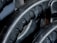 Close-up view of black rubber material with a textured pattern. The surface has grooves and dimples, suggestive of industrial machinery or equipment.