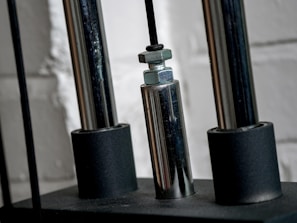 Close-up of a technician performing maintenance on a steel curtain door mechanism.