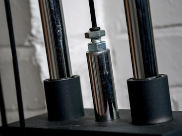 Close-up of a technician performing maintenance on a steel curtain door mechanism.
