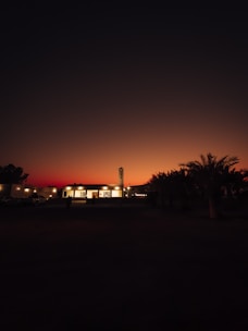 A serene view of pilgrims walking towards the Nabawi Mosque at sunset with warm golden light.