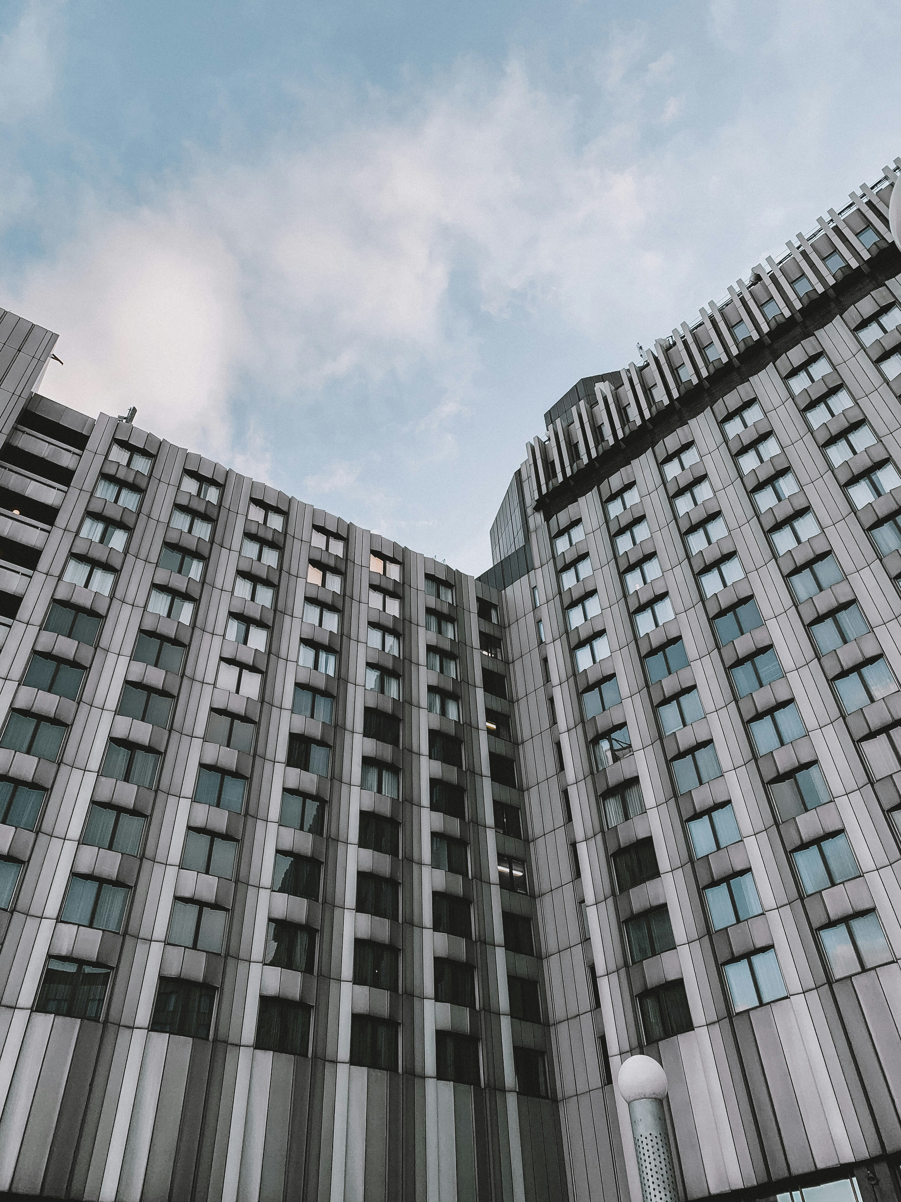 gray concrete building under white clouds during daytime