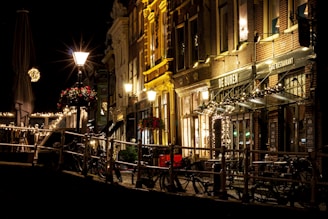 A cozy street scene in Amsterdam with bicycles and brick buildings bathed in warm light.