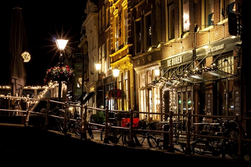 A cozy street scene in Amsterdam with bicycles and brick buildings bathed in warm light.