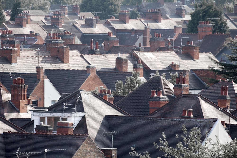 Rows of neighborhood rooftops with brick chimneys near Richmond, TX