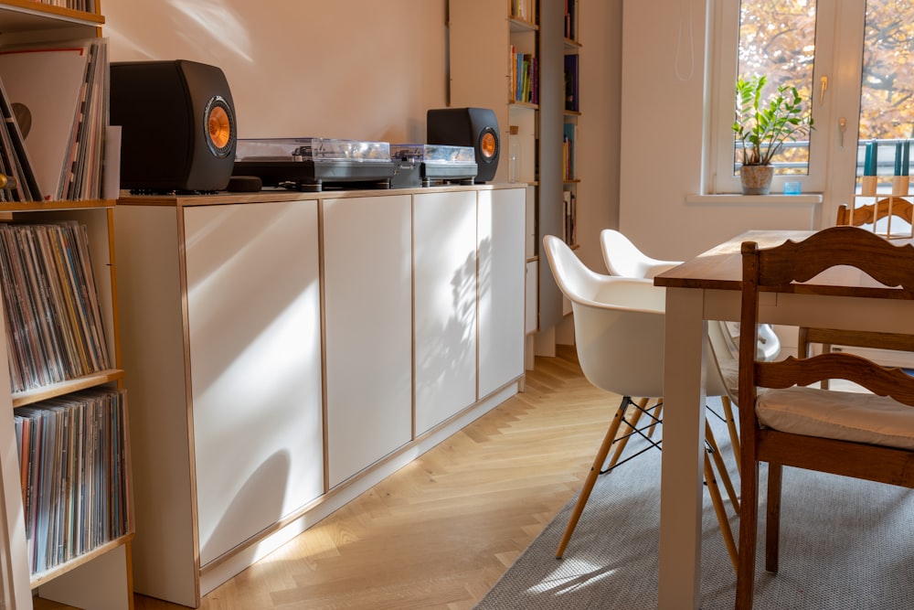 black and silver stereo component on white wooden cabinet