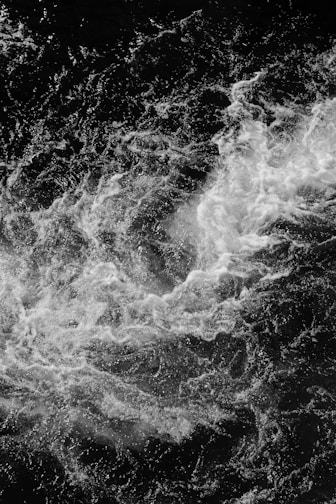 water waves in grayscale photography