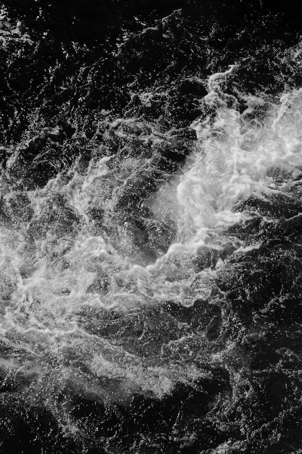 water waves in grayscale photography