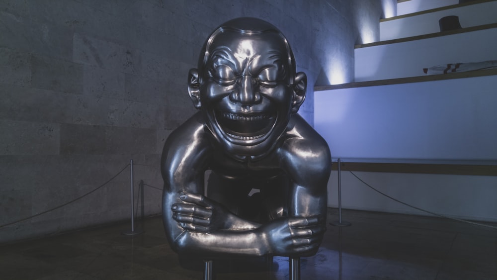 black human skull statue near blue wall