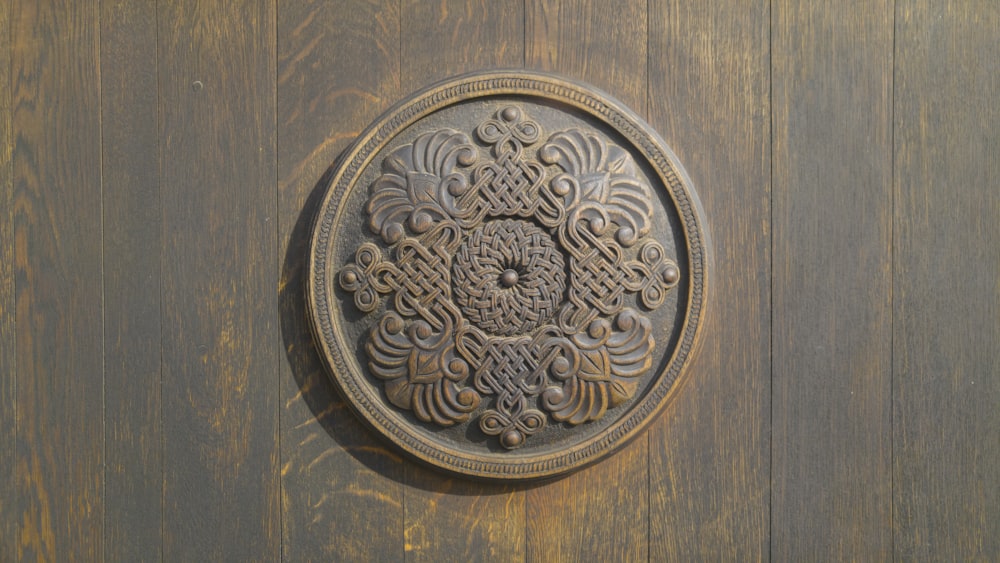 round brass round coin on brown wooden surface