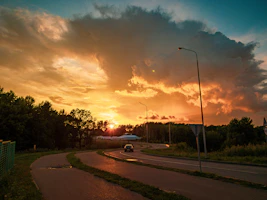 A scenic road stretching toward a sunset, inviting the viewer to imagine their journey.