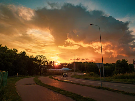 A scenic road stretching toward a sunset, inviting the viewer to imagine their journey.